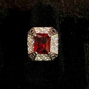 Garnet colored ring with rhinestones.
